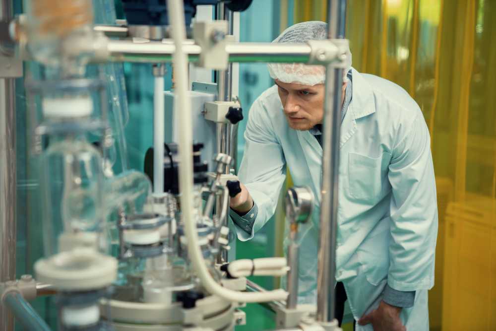 scientist examining cannabis extraction machinery