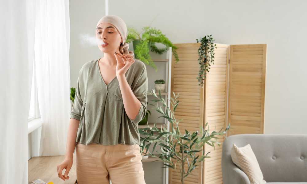 young woman wearing scarf smoking cannabis