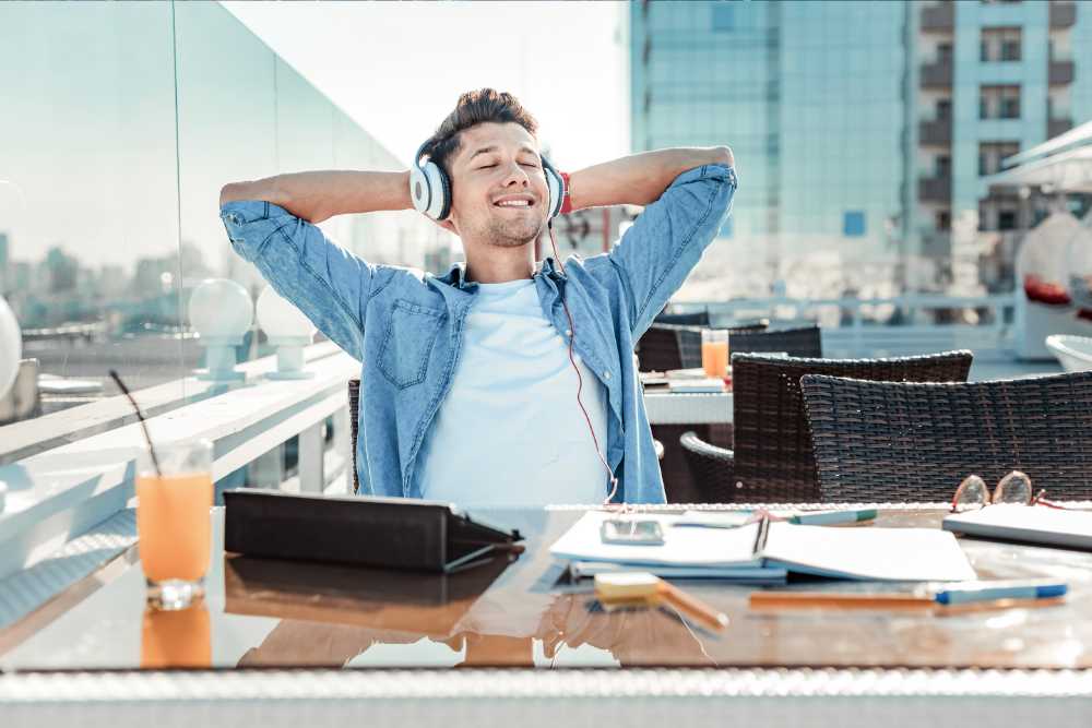 relaxed man listening to music on rooftop