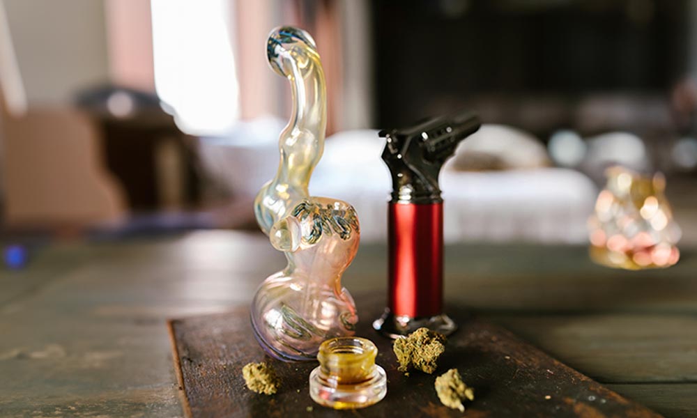 dab rig concentrate torch buds on wooden board