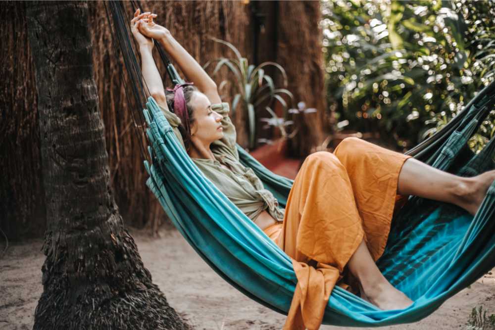 woman relaxing in turquoise hammock