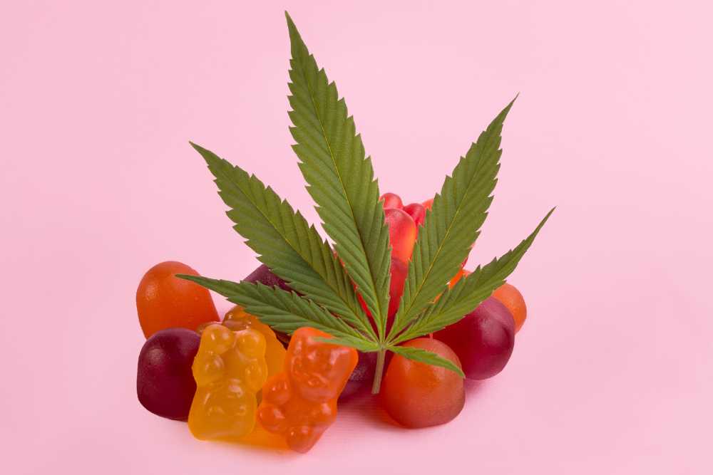 cannabis edibles in a pile with cannabis leaf on top