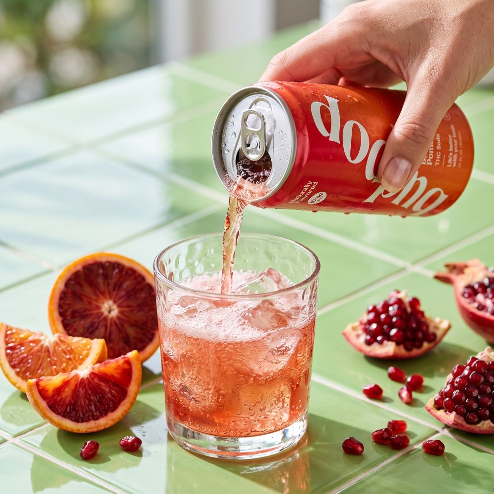 blood orange pomegranate pouring into glass with fresh fruit